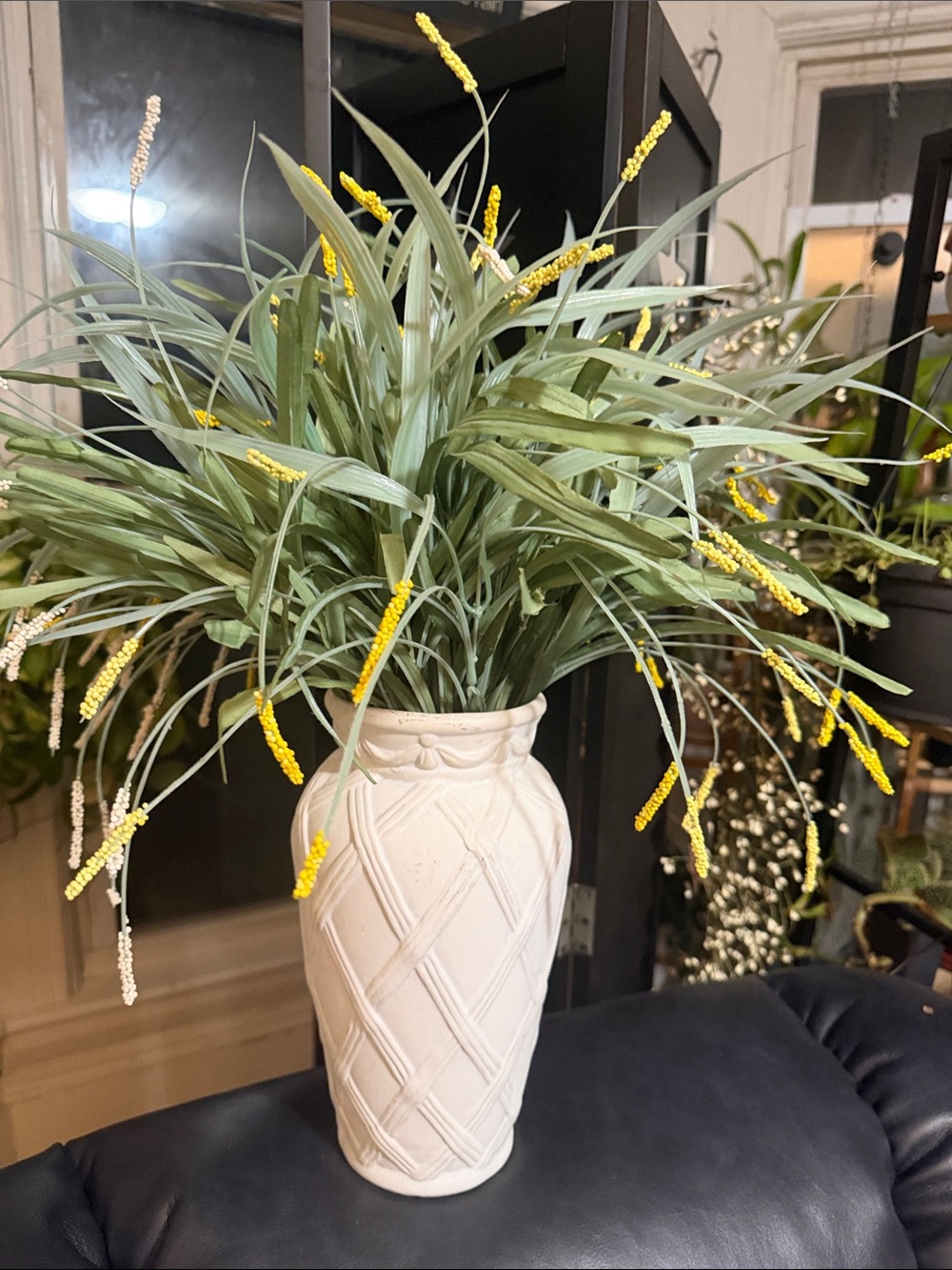 Vase with faux yellow an green flowers